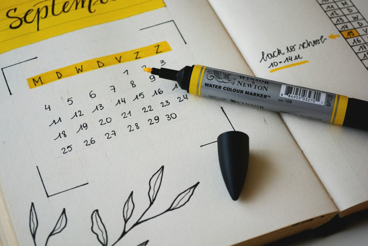 Open notebook listing tasks beside a pen